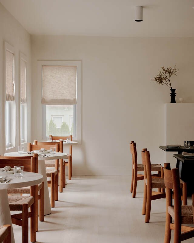 Porch seating for breakfast at The James Bradley with seasonal dishes and coastal light.